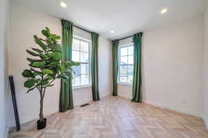 Empty room featuring light parquet floors