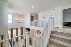 Stairs with an inviting chandelier