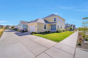 View of front of property with a garage and a front yard