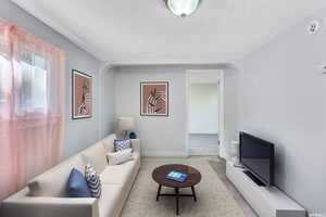 Virtual Staging. Living room featuring a textured ceiling and light hardwood / wood-style flooring