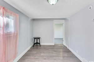 Spare room with a textured ceiling and hardwood / wood-style floors