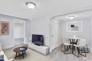 Virtual Staging. Interior space with a textured ceiling and light wood-type flooring