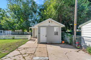 View of outdoor structure featuring a yard