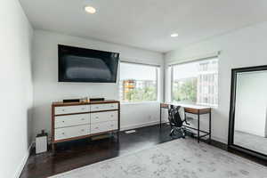 Office with a textured ceiling and dark hardwood / wood-style floors