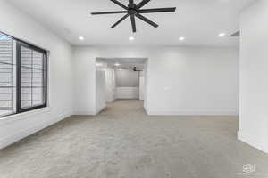 Unfurnished room with ceiling fan and light carpet