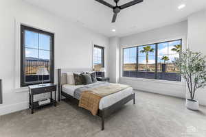 Carpeted bedroom featuring ceiling fan