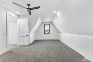 Bonus room featuring carpet floors, ceiling fan, and vaulted ceiling