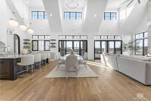 Dining area featuring a high ceiling, french doors, and plenty of natural light