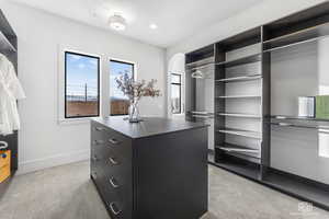 Spacious closet with light colored carpet