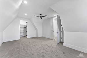 Bonus room featuring ceiling fan, lofted ceiling, and carpet flooring