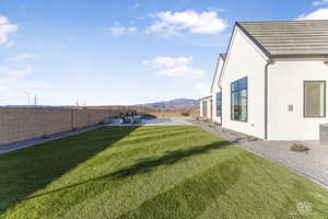 View of yard featuring a swimming pool, a patio area, and a mountain view