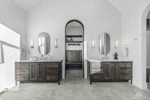 Bathroom with high vaulted ceiling and vanity