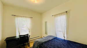 Bedroom with a baseboard heating unit