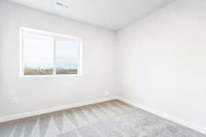 Unfurnished room with carpet