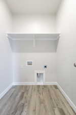 Laundry room featuring hookup for an electric dryer, light hardwood / wood-style flooring, and hookup for a washing machine