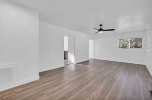 Unfurnished room featuring ceiling fan and hardwood / wood-style floors