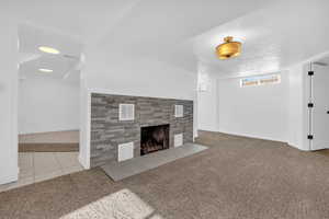 Unfurnished living room featuring a textured ceiling and tile patterned floors