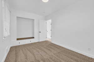 Unfurnished bedroom featuring a closet and carpet floors