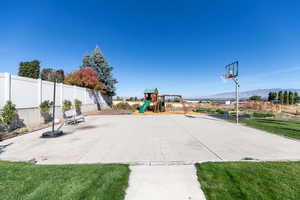 Backyard with a Playground, Basketball Court, and mountain views