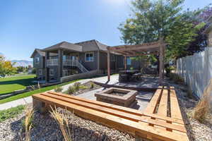 Exterior space featuring a Firepit,  a Pergola, a patio area, and mountain views.