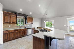 The kitchen features rich wood cabinetry, stainless steel appliances, and ample counter space