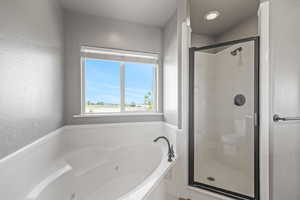 Master Bathroom with double vanity, a beautiful jetted tub and a walk-in-shower