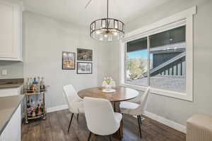 Dining room featuring an inviting chandelier and dark hardwood / wood-style floors