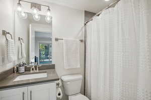 Bathroom featuring vanity, toilet, a textured ceiling, and a shower with shower curtain