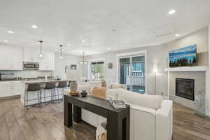 Living room featuring a textured ceiling, dark hardwood / wood-style floors, sink, and a tiled fireplace