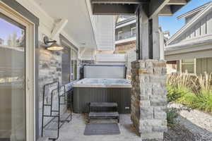 View of patio / terrace featuring a hot tub and central AC