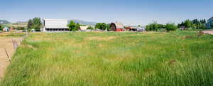 View of yard with a rural view and a mountain view