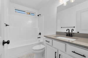 Full bathroom with shower / bathing tub combination, vanity, and toilet