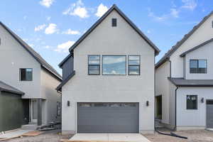 View of back facade featuring a garage