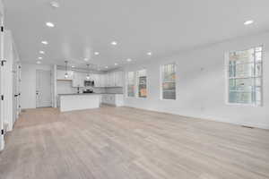 Unfurnished living room with light hardwood / wood-style floors