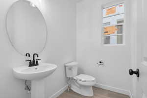 Bathroom with wood-type flooring and toilet