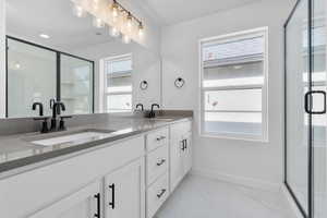 Bathroom with an enclosed shower and vanity