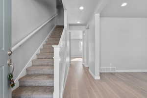 Stairway with hardwood / wood-style flooring