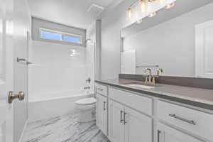 Full bathroom with vanity, toilet, and washtub / shower combination