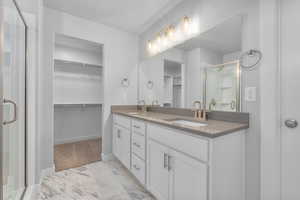 Bathroom featuring vanity and walk in shower