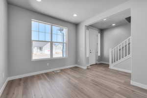 Entryway featuring a textured ceiling and light wood-type flooring