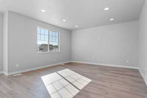 Spare room with light wood-type flooring