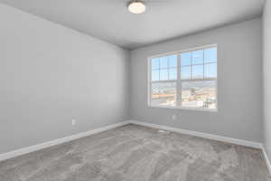 Carpeted empty room featuring a healthy amount of sunlight and a textured ceiling