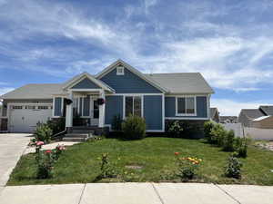 View of front of home featuring a front yard and a garage