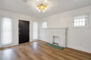 Unfurnished living room featuring a fireplace and hardwood / wood-style flooring