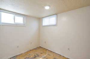 Basement featuring a textured ceiling