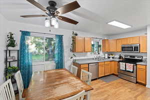 Kitchen featuring light hardwood / wood-style floors, appliances with stainless steel finishes, plenty of natural light, and sink