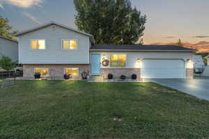 Tri-level home with a yard and a garage