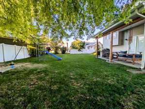 View of yard with a playground, an outdoor living space, and a patio