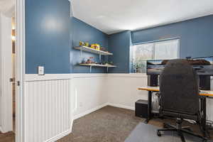 Office space featuring a textured ceiling and carpet flooring