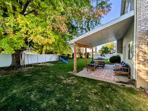 View of yard with a playground and a patio area